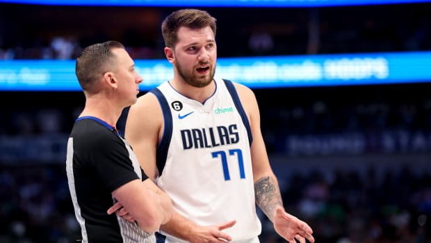 Mavericks guard Luka Doncic speaks with a referee.
